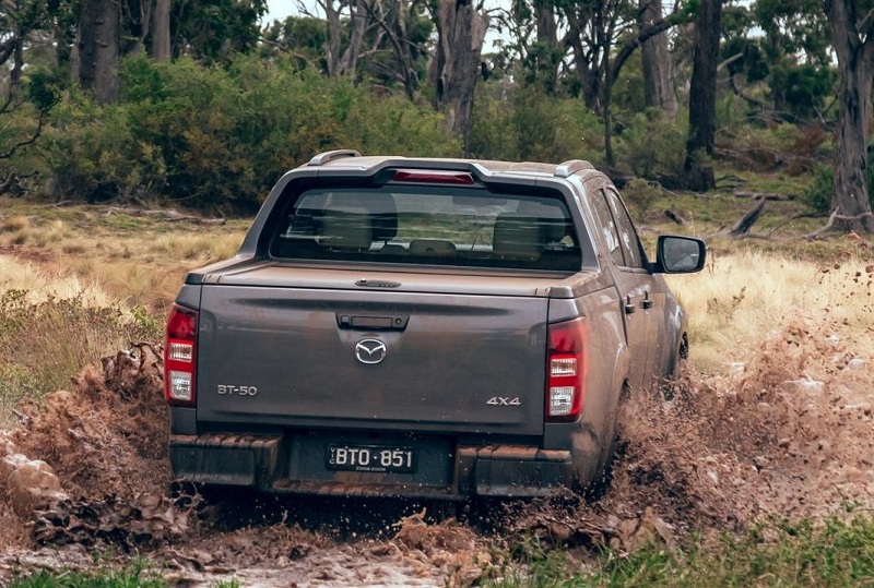 Back view of silver Mazda BT-50 driven in nature